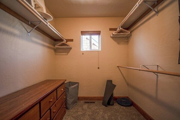 A narrow hallway with a wooden dresser, a small window, and a metal rack. - Sunlit home with hot tub, A/C and soaring ceilings, near City Beach (Dover)