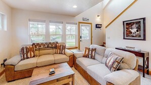 A living room with two sofas, a coffee table, and a framed picture on the wall.