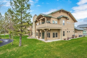 A two-story building with a green roof, multiple windows, and a front porch. - Elegant, newer, 1st-floor condo with private hot tub - steps to resort marina (Dover)