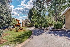 A residential street with houses, a driveway, and a well-maintained lawn. - Lakefront home with kayaks, dock, WiFi, fireplaces, BBQ grill (Hope)