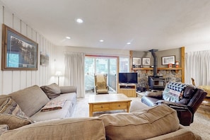 A living room with a sofa, armchair, coffee table, and a fireplace. - Three bedroom Condo w/Shared Pool, Hot Tub, Near Town and Ski Resort (Mammoth Lakes)