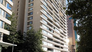 En hög byggnad med många våningar, stora fönster och en modern arkitektonisk design.