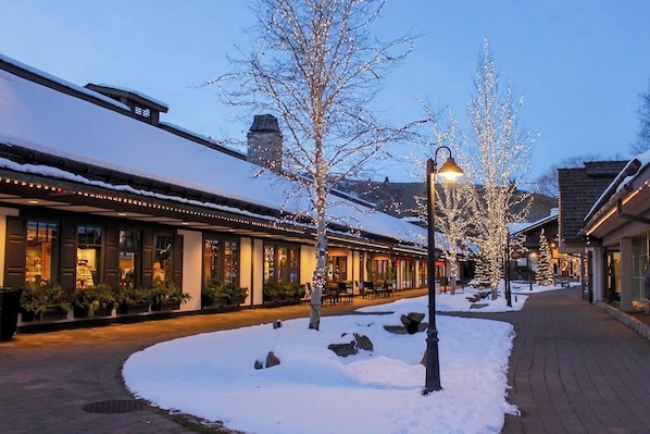 A snow-covered outdoor area with a building featuring large windows and a brick facade. - Thoughtfully renovated condo with Sun Valley pass to pool & tennis (Sun Valley)