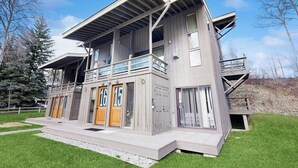 A modern two-story building with a balcony, large windows, and a flat roof. - Wonderful Mountain Getaway W/ Shared Pool, Multiple Balconies, Gas Grill & WiFi (Ketchum)