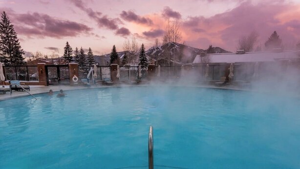 A pool with a clear view of the surrounding area, including a mountain in the background.