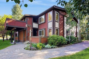 A modern two-story building with a covered outdoor area, a paved driveway, and landscaped greenery. - Lovely Studio Close to Dollar Mountain w/Full Kitchen/ Free WiFi/ Deck/ Netflix (Sun Valley)