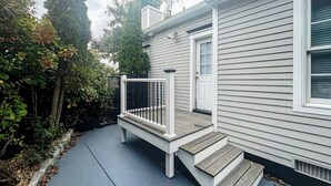 A house with a front porch, a door, and a window.