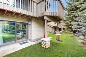 A modern house with a deck, a glass door entrance, and a stone pillar. - Gorgeous mountain retreat with pool, hot tub, games, & golf - walk-to-lifts (Sun Valley)