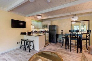A spacious kitchen with a dining area, wooden ceiling, and modern appliances. - Cozy Sun Valley condo, walk to village, skiing and mountain adventures (Sun Valley)