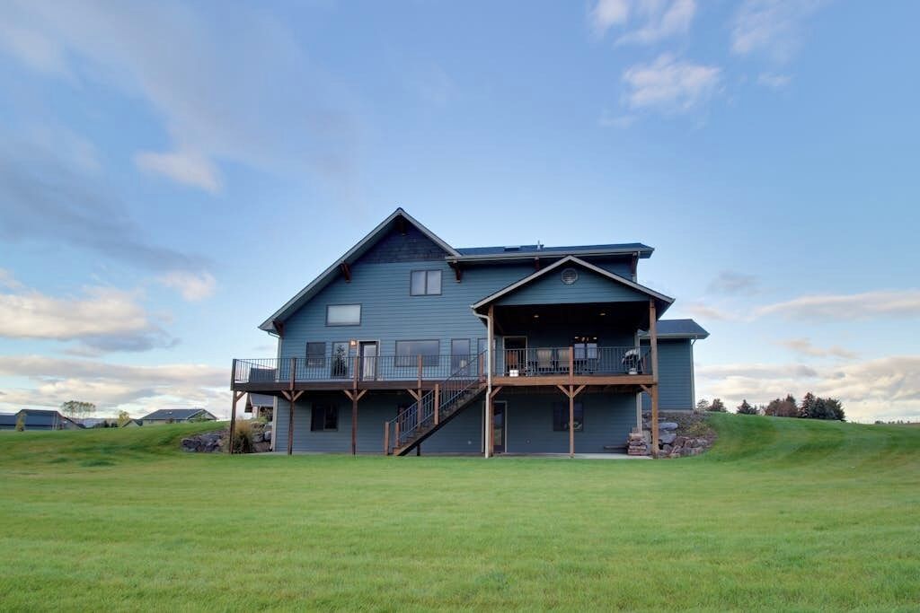 A large two-story house with a balcony and a covered porch.