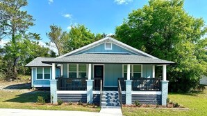 A single-story house with a gabled roof, a front porch, and a front yard. - Renovated Gulf Coast Home - Walk to Marina, Dining, & Downtown Carrabelle (Carrabelle)