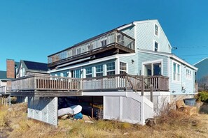 A two-story house with a balcony, a garage, and a covered outdoor area.
