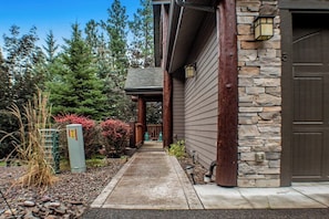 A building with a stone facade, wooden beams, and a door.