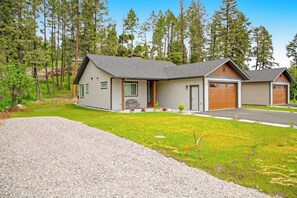 A two-story house with a front porch, a garage, and a driveway. - Relaxing single-level home with a patio, washer/dryer, & central AC (Lakeside)