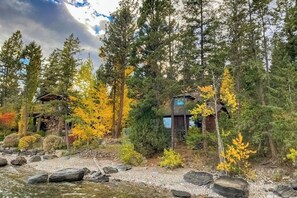 A traditional Japanese-style building surrounded by autumn foliage and a rocky stream. - Lakefront home with amazing mountain views, wraparound deck, fireplace, & grill (Lakeside)