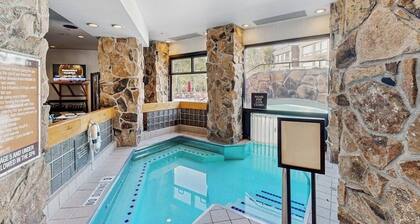 Ski-in/out condo with mountain view, hot tub, pool, & fireplace