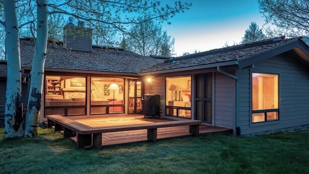 A modern house with a deck, large windows, and a visible garage. - Beautiful, modern townhome next to the golf course with WiFi and full kitchen (Jackson)