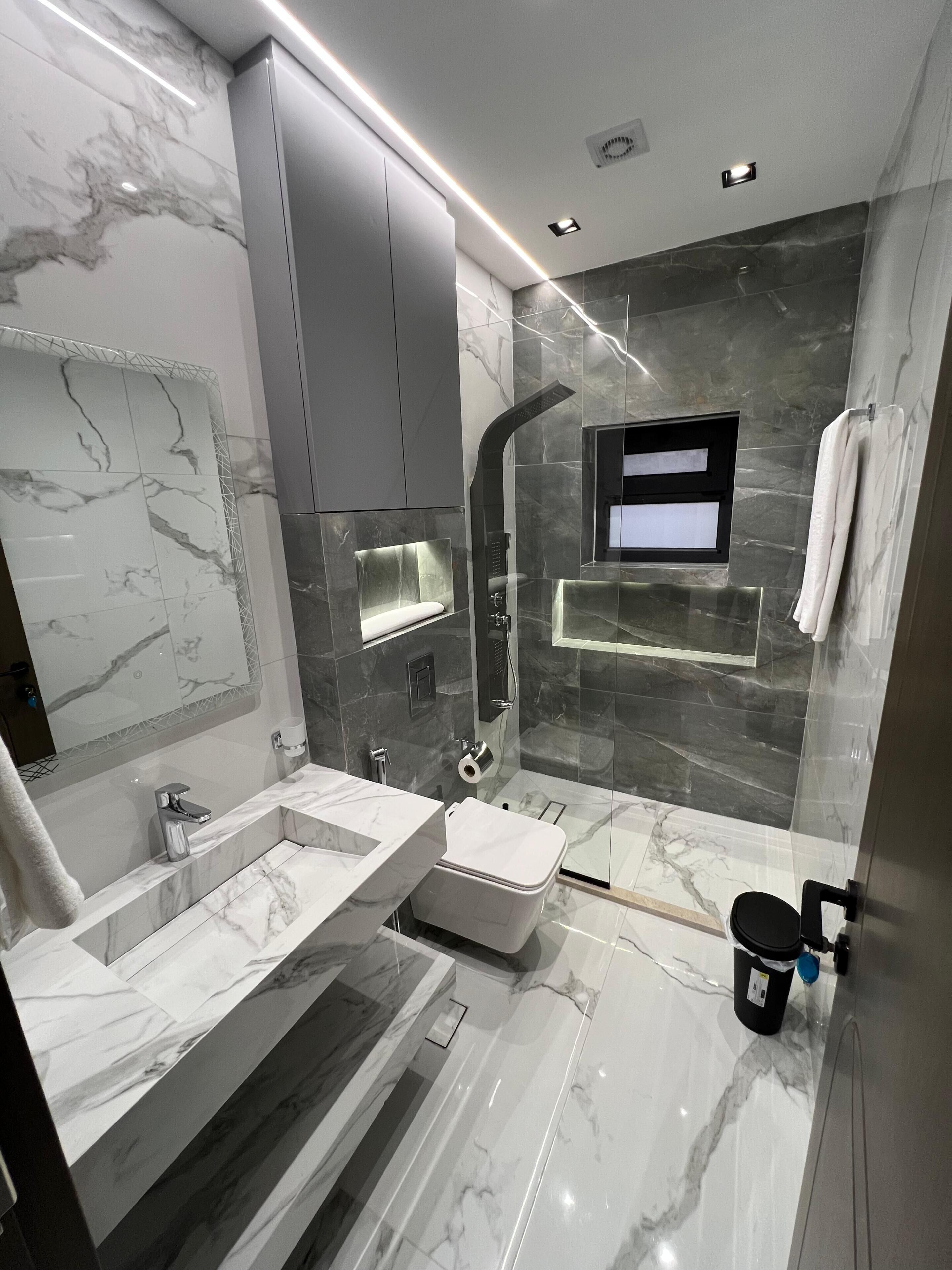 Separate bathtub and shower, towels, soap, shampoo