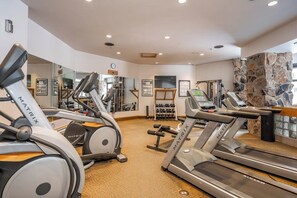 A gym with treadmills, elliptical machines, and weight equipment. - Ski-in/ski-out condo in the village w/ shared pool/hot tub, sauna, gym & more (Big Sky)