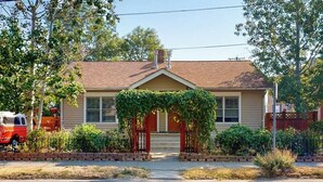 A single-story house with a front porch, a garage, and a driveway. - Modern duplex with gas fireplace, free WiFi, & walkable downtown location (Bozeman)