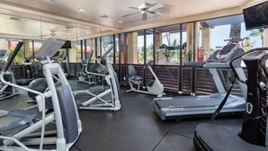 A gym with treadmills, elliptical machines, and stationary bikes.