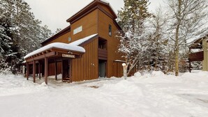 A wooden building with a covered entrance and a sign reading 'TAMARACK.' - Beautiful country home with full kitchen & views from the private balcony (Wilson)