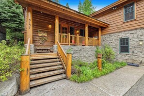 A wooden lodge with a stone facade, a porch with steps, and a sign indicating it is a 'Loose Moose Lodge.' - Spacious Cozy Cabin w/ Deck, Private Hot Tub, Grill - Amazing In-Village Locale (Teton Village)