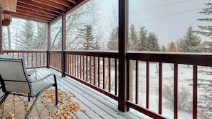 A wooden deck with a view of a snowy landscape.