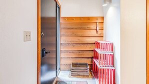 A wooden interior with a sliding door, a wooden wall, and red crates. - Lovely condo with fireplace, skiing, balcony, full kitchen & washer/dryer (Wilson)