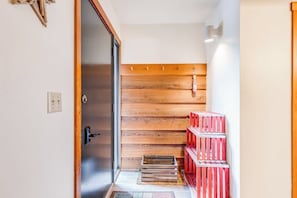 A wooden interior with a sliding door, a wooden wall, and red crates. - Lovely condo with fireplace, skiing, balcony, full kitchen & washer/dryer (Wilson)