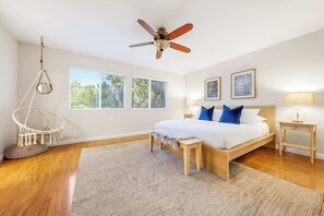 A bedroom with a bed, bedside tables, a hanging chair, and a ceiling fan. - **NEW**Backyard Dream - 5BR l Pool l Spa (Vista)