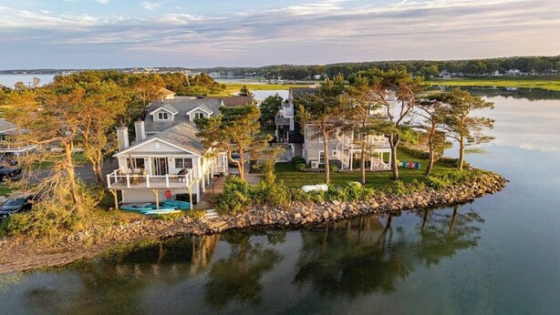 A lakeside property with multiple houses, a dock, and a swimming pool. - Ocean View, Riverfront Home w/ Marsh Views, 2 Decks, Kayaks - Walk to Beach (Wells)