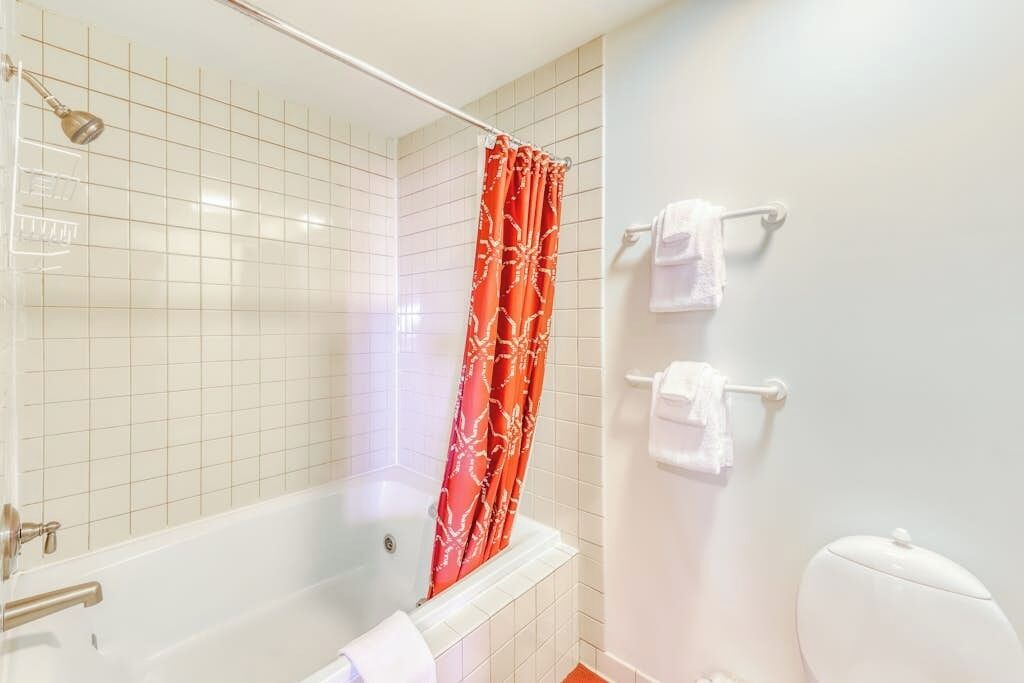 A bathroom with a bathtub, a shower, and a toilet.