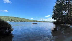 A calm lake with a dock, surrounded by dense forest. - Tranquil Lakefront Retreat with large outdoor patio, beach and Stunning Views (Denmark)