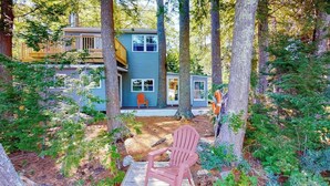 A cabin with a deck, surrounded by trees. - Entire lakefront home on Togus Pond with decks, canoe, firepit & great view (Augusta)