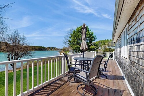 Tranquil waterfront home with stunning views, a spacious deck, and a BBQ grill