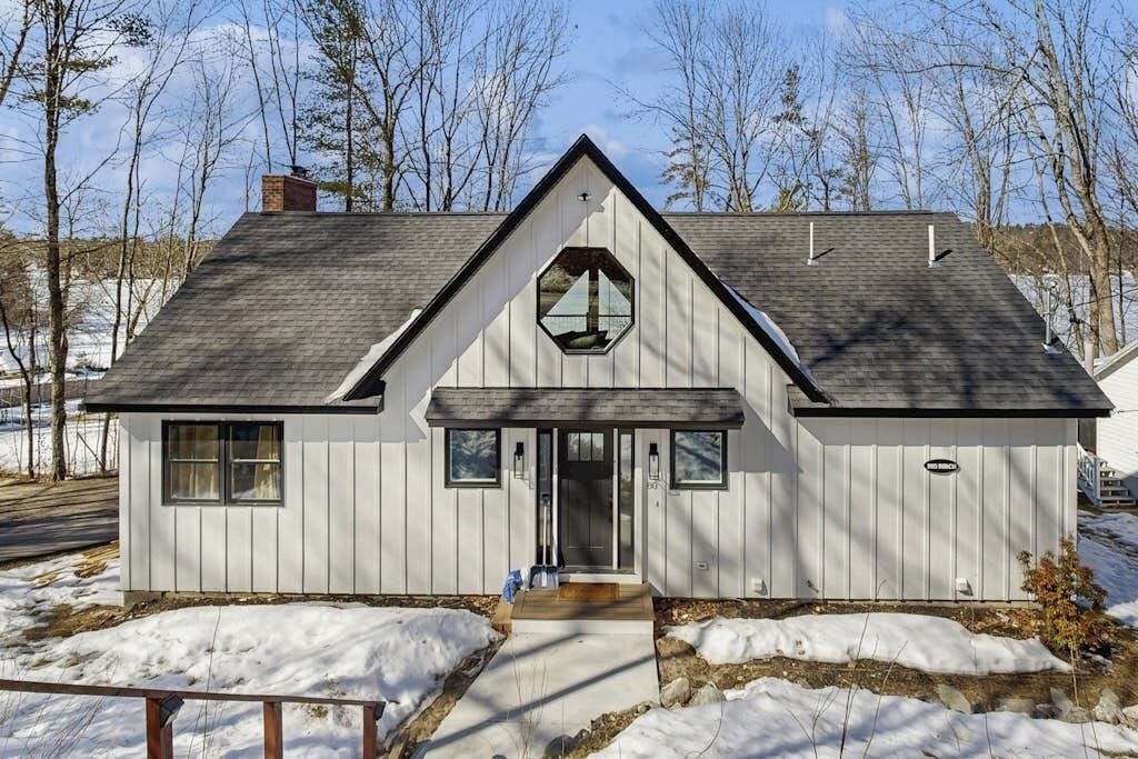 A single-story house with a gabled roof, a front entrance, and a small porch.