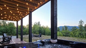 A hot tub under a wooden pergola with a view of mountains and trees. - Spacious mountain retreat with fire pit, hot tub, sauna, and foosball (Bethel)