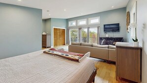 A bedroom with a bed, a sofa, a television, and a desk. - Spacious Mountain Chalet with Sauna, Deck, and Ski/Snowboard Adventures Nearby (Bethel)