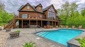 A wooden cabin with a pool, outdoor seating, and a covered patio. - Stunning mountain-view estate with private pool & hot tub - near slopes (Newry)