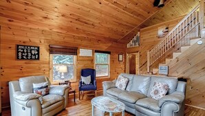 A wooden cabin interior with a sofa, armchair, and a small table. - Fantastic Lakefront Cabin W/ Free WiFi, Three Kayaks, Private Dock, & Firepit (Winthrop)