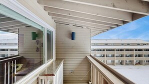 A balcony with a view of a building with multiple floors and a clear sky. - Ski-in/out 2-story condo with balcony, on-site indoor pool, hot tub, sauna, W/D (Newry)