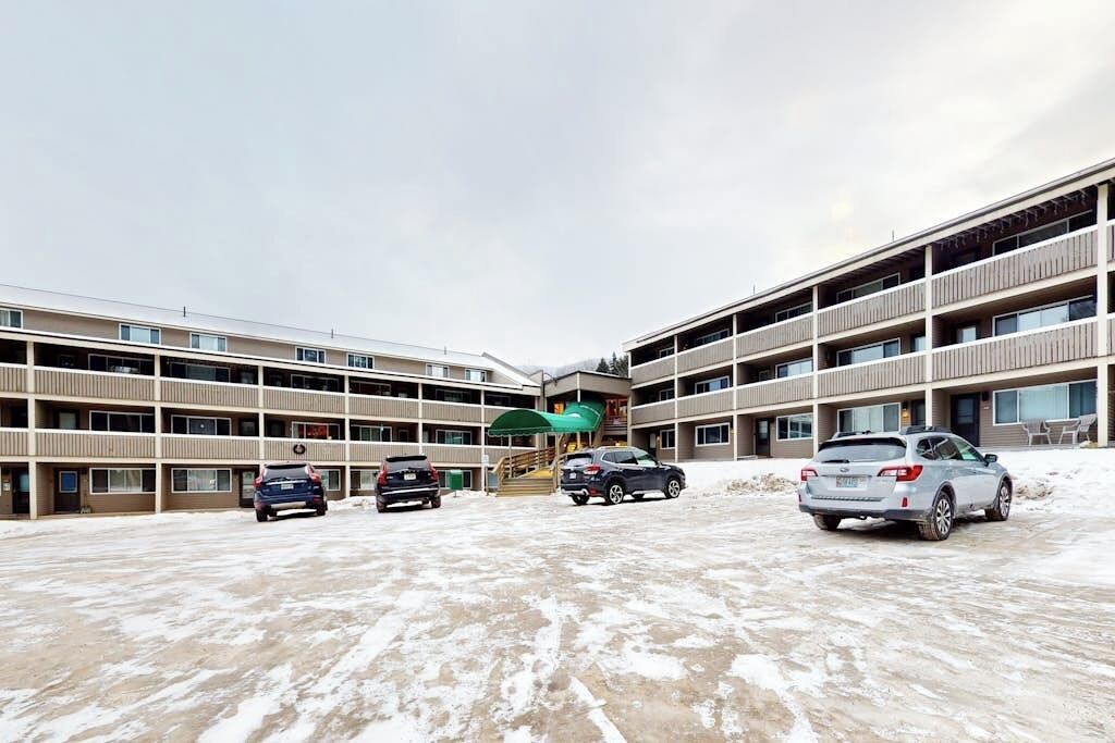 A multi-story parking garage with several cars parked.