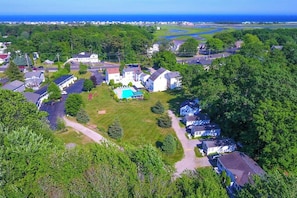 A residential area with houses, a swimming pool, and a view of the ocean.