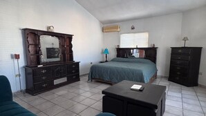 A bedroom with a bed, dresser, and a desk with a chair. - Special house to spend a pleasant time (El Caballito)