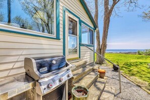 A grill outside a house with a view of the ocean. - Beautiful waterfront house & cottage w/ a firepit - walk to the beaches & town (York)