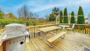 A wooden deck with a grill, picnic table, and chairs. - Adorable nautical home close to town, W/D, & streaming, dog friendly (Wells)