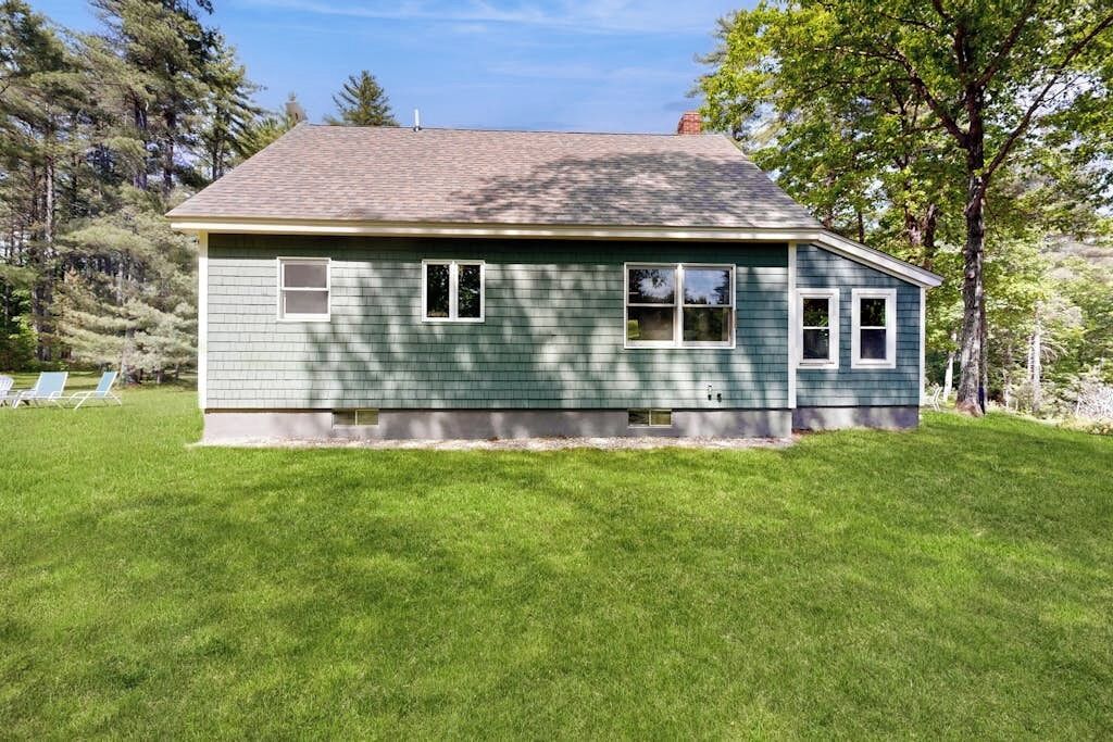 A single-story house with a sloped roof, a front porch, and a well-maintained lawn.