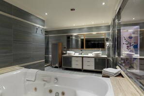 A modern bathroom with a large bathtub, a double vanity with two sinks, and a glass shower enclosure. - Magic Balneario (Oropesa del Mar)