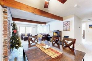 A dining area with a wooden table, chairs, and a Christmas tree. - Snowbird-friendly home with heated pool, sauna, game room, tennis, BBQ, W/D (Bartlett)